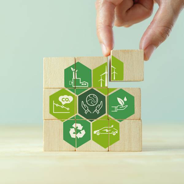Save,Of,Earth,,Saving,Environment,,Net,Zero,Emissions,Concept.,Green Save of earth, saving environment, net zero emissions concept. Green business and sustainable development. World earth day. Hand puts wooden cubes with clean energy icon standing on eco friendly icon.